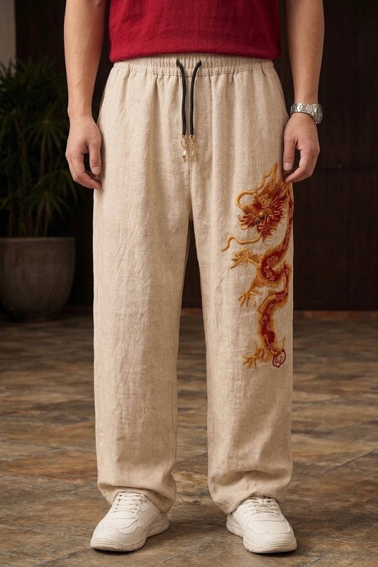 Beige Chinese dragon baggy pants for unisex with red and gold 3D embroidery by Suspended Clothing.