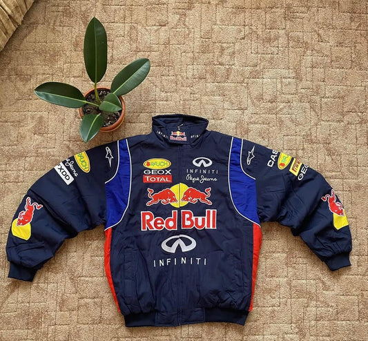 Vintage Red Bull motorsport embroidered racing jacket with oversized fit, displayed on carpet.
