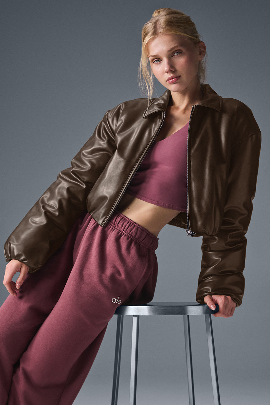 Back view of Suspended Clothing brown women's cropped leather bomber jacket with ribbed hem