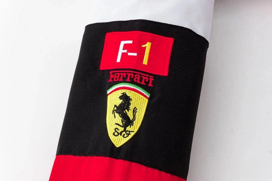 Close-up of the direct-stitch Formula 1 team patches on the breathable cotton-twill red racing jacket
