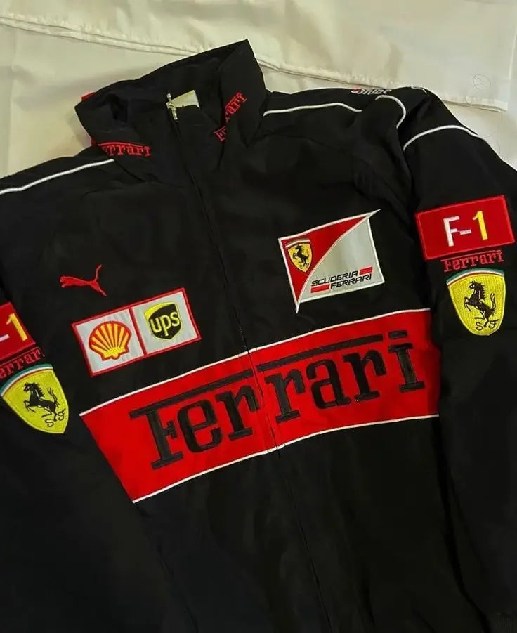 Close-up of black Ferrari racing jacket with vintage motorsport patches and red accents.