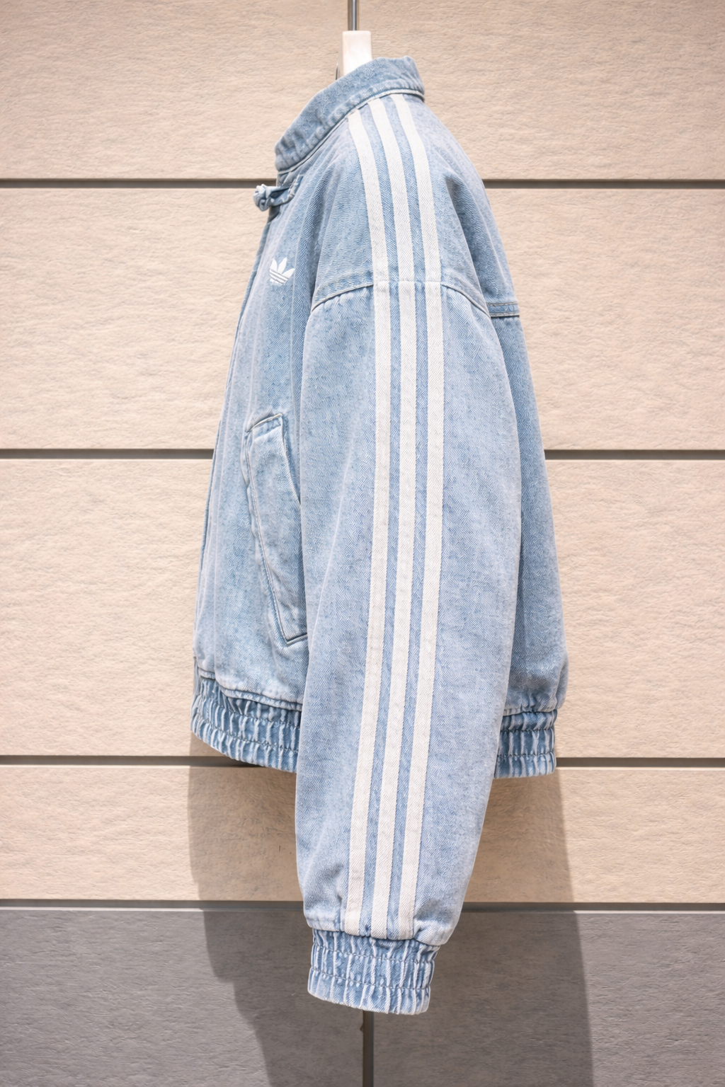 Detailed view of the drop-shoulder stitching and wide-body cut on the Suspended Clothing denim layer.