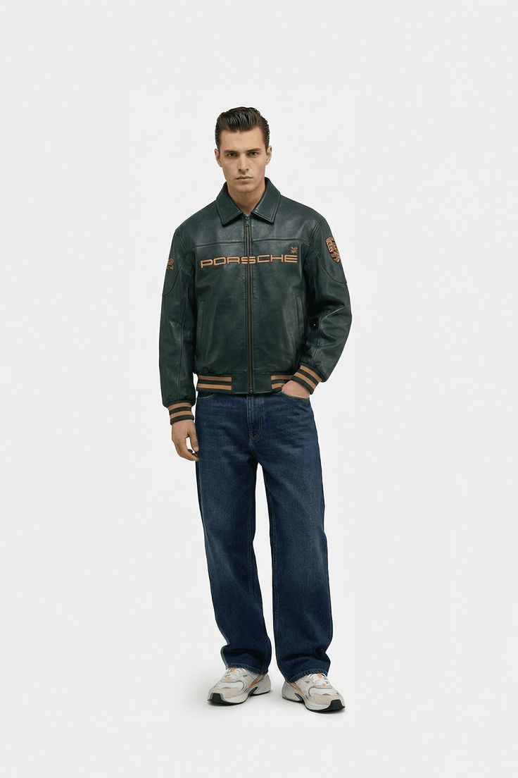 Man wearing a green Porsche jacket and blue jeans on a white background