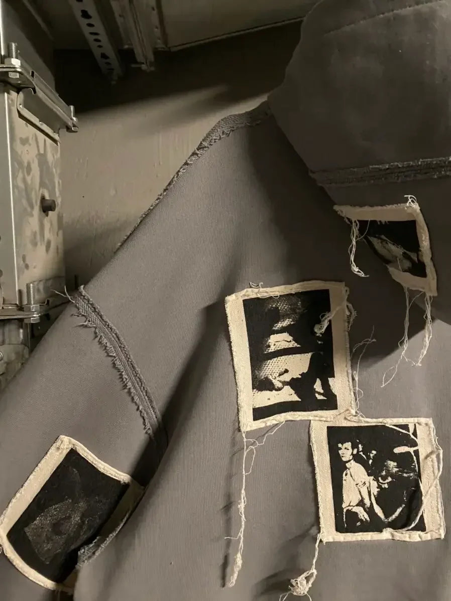 Gray streetwear jacket with raw seam details and black graphic fabric patches, Y2K fashion style