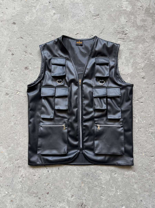 Model standing in the techwear vest black, wearing the ultimate black tactical vest for urban outfit.