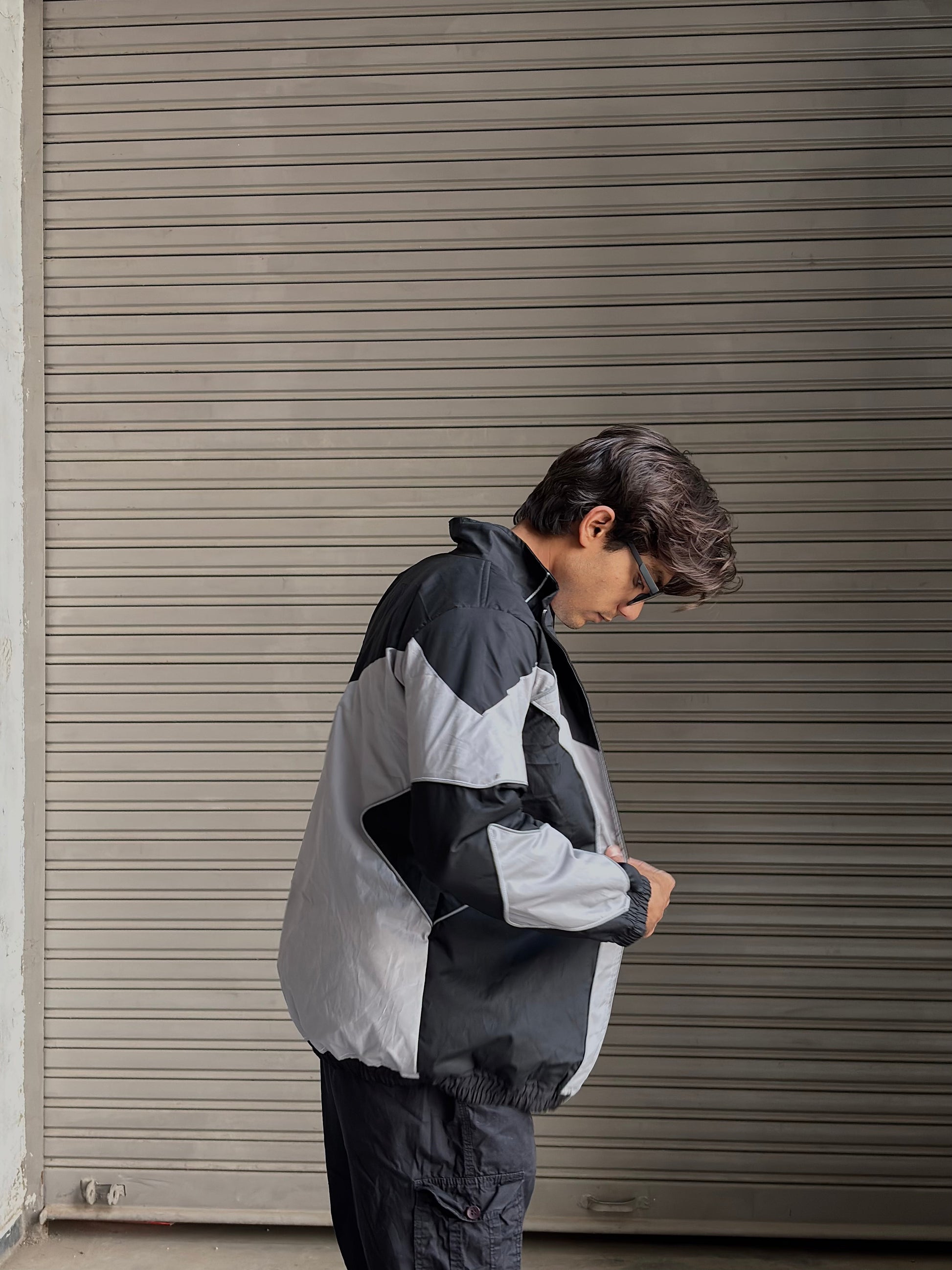 Model styling the breathable parachute jacket with baggy cargos and sneakers.