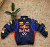 Vintage Red Bull motorsport embroidered racing jacket with oversized fit, displayed on carpet.