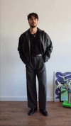 Suspended Clothing black faux leather jacket, featuring the best black vegan leather jacket for streetwear aesthetic.