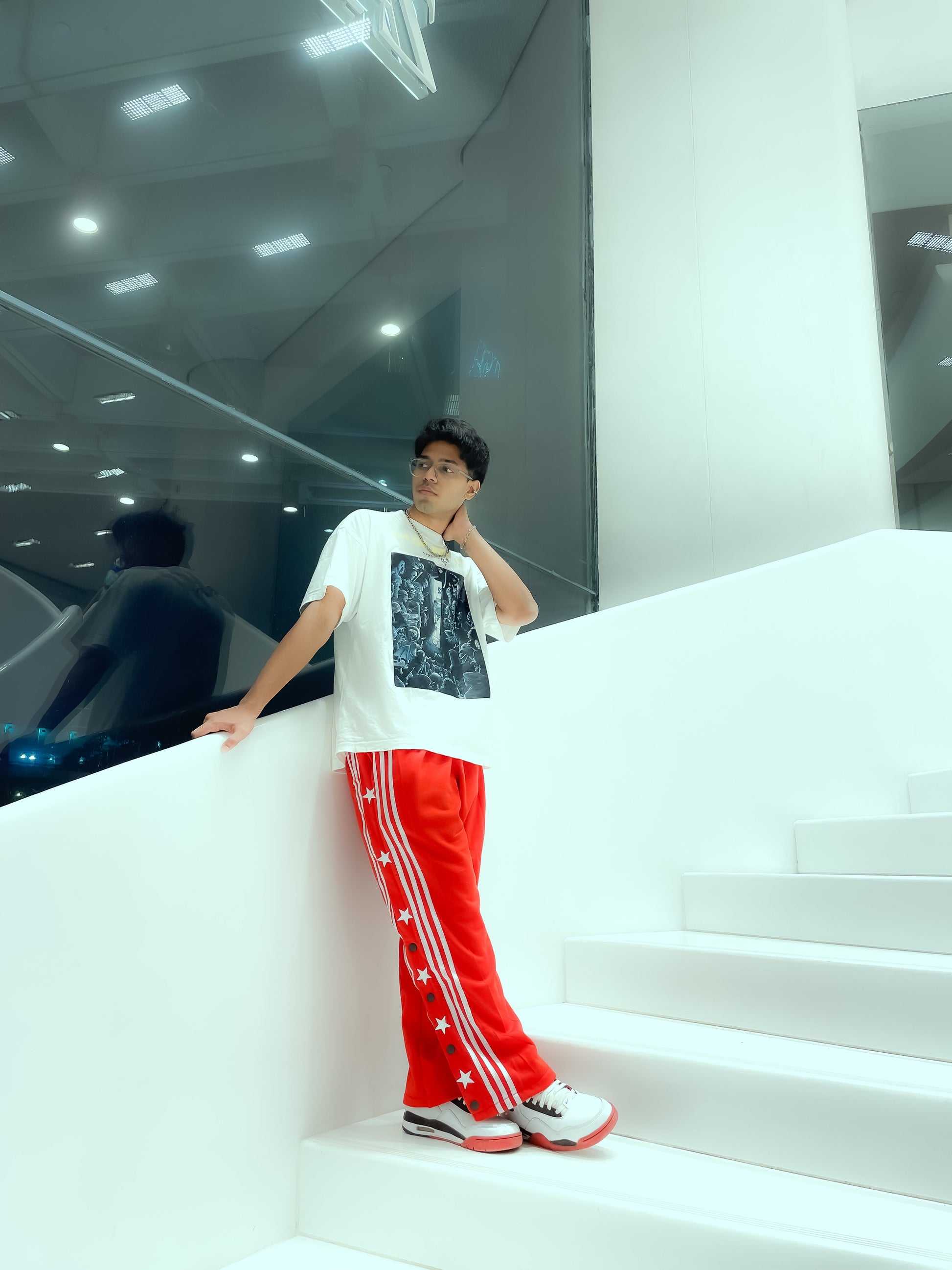 Suspended Clothing black retro snap button track pants showing elastic waistband and back pocket detail.