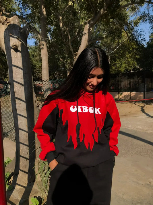 Woman wearing black and red flame graphic oversized hoodie outdoors