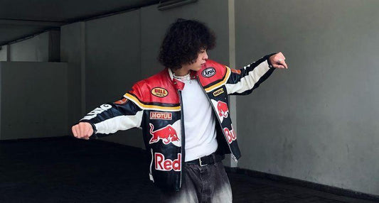 Man in navy Red Bull racing leather jacket with boxy streetwear silhouette posing outdoors