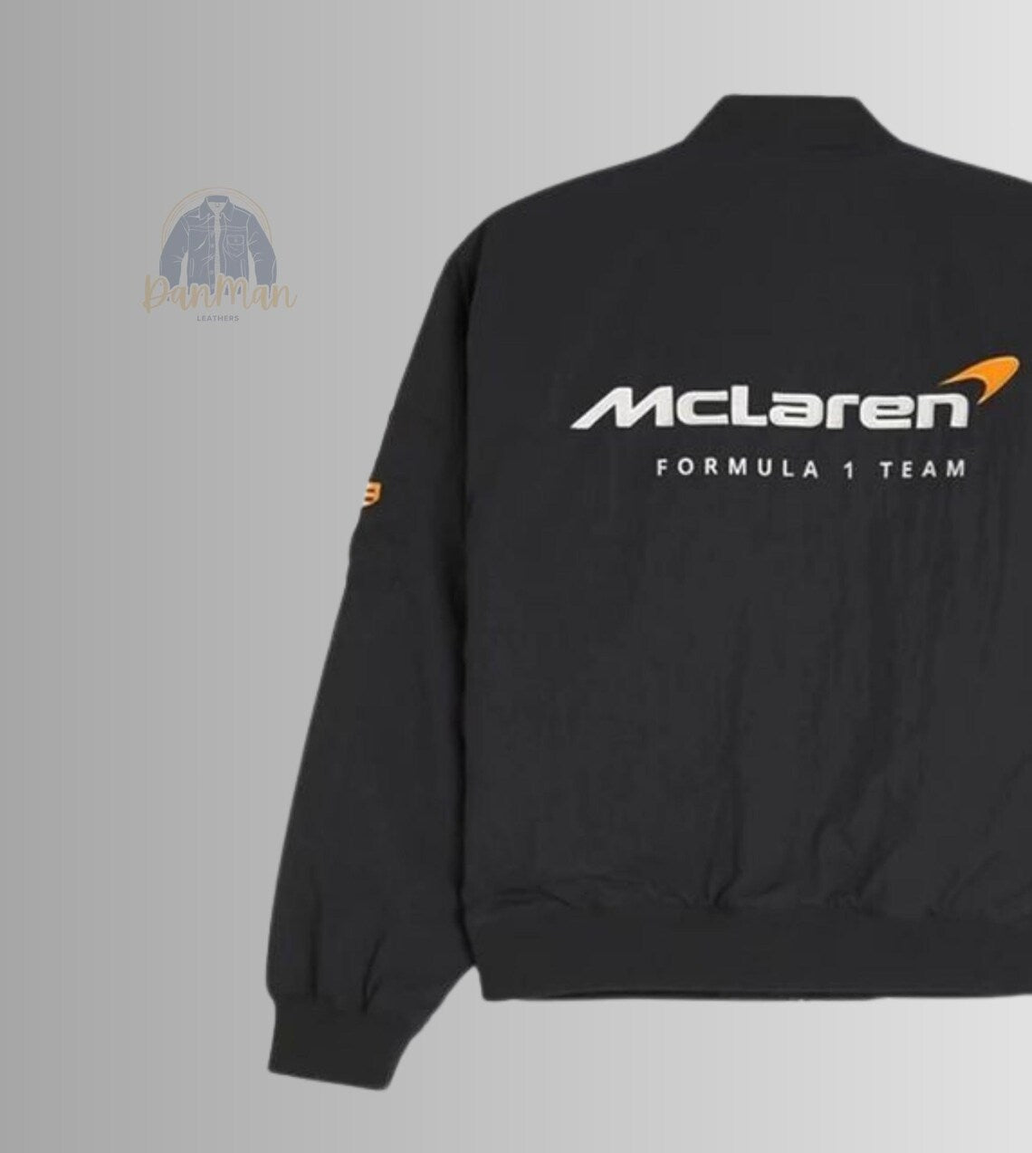 the functional front zipper and elasticated cuffs of the lightweight black F1 track jacket.