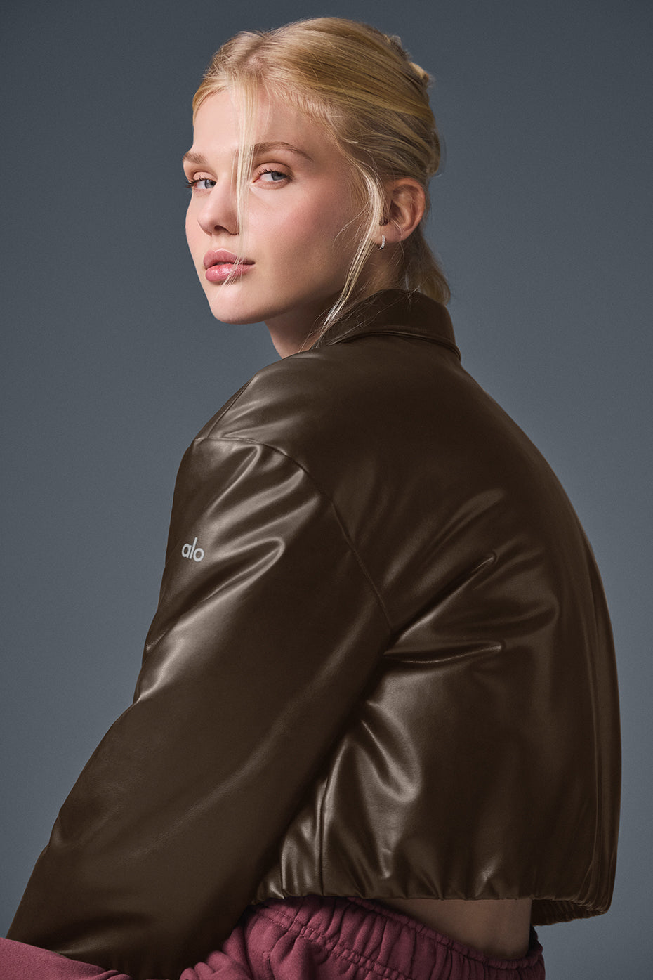 Back view of Suspended Clothing brown women's cropped leather bomber jacket with ribbed hem